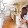 Young,Military,Couple,Looking,Inside,Custom,Kitchen,And,Design,Drawing