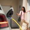 Close,Up,Of,A,Electric,Car,Charger,With,Female,Silhouette