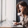 Young,Woman,Holding,Credit,Card,And,Using,Laptop,Computer.,Businesswoman