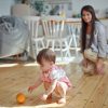 Young,Mother,Watching,Her,Cute,Baby,Daughter,Playing,Orange,Fruit