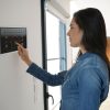 Woman,Using,Smart,Wall,Home,Control,System